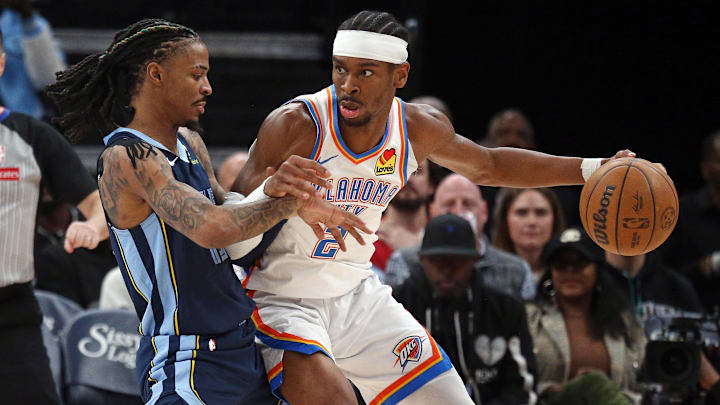 Mar 5, 2025; Memphis, Tennessee, USA; Oklahoma City Thunder guard Shai Gilgeous-Alexander (2) dribbles as Memphis Grizzlies guard Ja Morant (12) defends during the third quarter at FedExForum. Mandatory Credit: Petre Thomas-Imagn Images Mar 5, 2025; Memphis, Tennessee, USA; Oklahoma City Thunder guard Shai Gilgeous-Alexander (2) dribbles as Memphis Grizzlies guard Ja Morant (12) defends during the third quarter at FedExForum. Mandatory Credit: Petre Thomas-Imagn Images