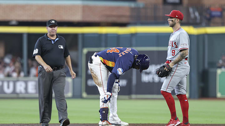 Houston Astros left fielder Yordan Alvarez (44) holds his leg after hitting a double as Los Angeles Angels shortstop Zach Neto (9) looks on during the third inning at Minute Maid Park on Sept 22. Houston Astros left fielder Yordan Alvarez (44) holds his leg after hitting a double as Los Angeles Angels shortstop Zach Neto (9) looks on during the third inning at Minute Maid Park on Sept 22.
