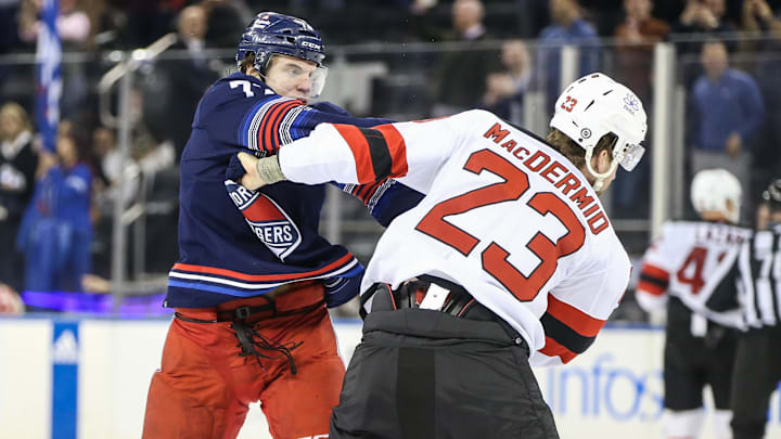 Apr 3, 2024; New York, New York, USA; New York Rangers center Matt Rempe (73) and New Jersey Devils defenseman Kurtis MacDermid (23) fight at the start of the first period at Madison Square Garden. Mandatory Credit: Wendell Cruz-USA TODAY Sports