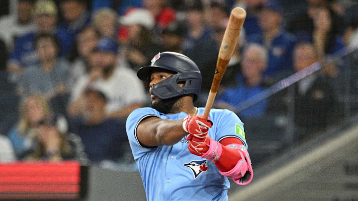 Sep 24, 2024; Toronto, Ontario, CAN; Toronto Blue Jays designated hitter Vladimir Guerrero Jr. (27) hits a two run RBI double against the Boston Red Sox in the third inning at Rogers Centre. Mandatory Credit: Dan Hamilton-Imagn Images