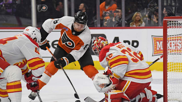 Mar 4, 2025; Philadelphia, Pennsylvania, USA; Philadelphia Flyers defenseman Cam York (8) takes shot on Calgary Flames goaltender Dustin Wolf (32) during the first period at Wells Fargo Center.