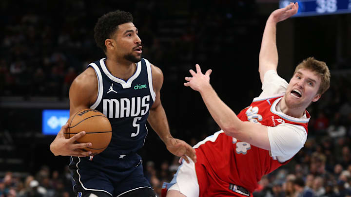 Jan 6, 2025; Memphis, Tennessee, USA; Dallas Mavericks guard Quentin Grimes (5) drives to the basket as Memphis Grizzlies guard Cam Spencer (24) defends during the second quarter at FedExForum. Mandatory Credit: Petre Thomas-Imagn Images