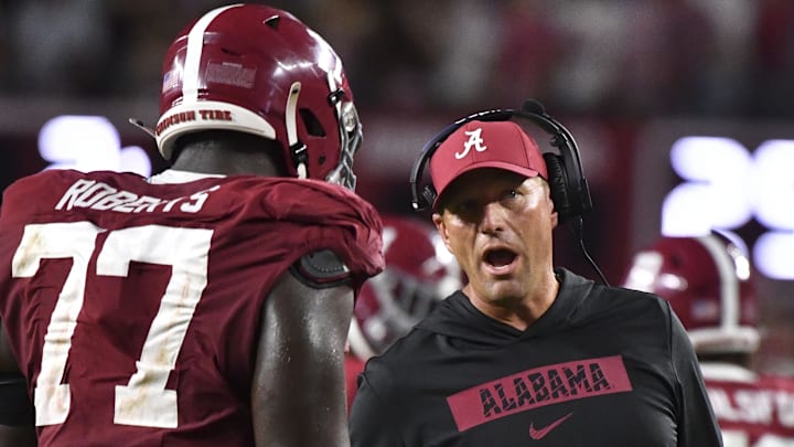Sep 28, 2024; Tuscaloosa, Alabama, USA;  Alabama Crimson Tide head coach Kalen DeBoer talks to offensive lineman Jaeden Roberts (77) during a game against the Georgia Bulldogs at Bryant-Denny Stadium. Alabama defeated Georgia 41-34. Mandatory Credit: Gary Cosby Jr.-Imagn Images