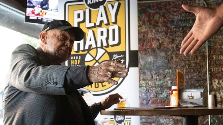 Former Purdue men’s basketball coach Gene Keady shakes the hand of an attendee 
