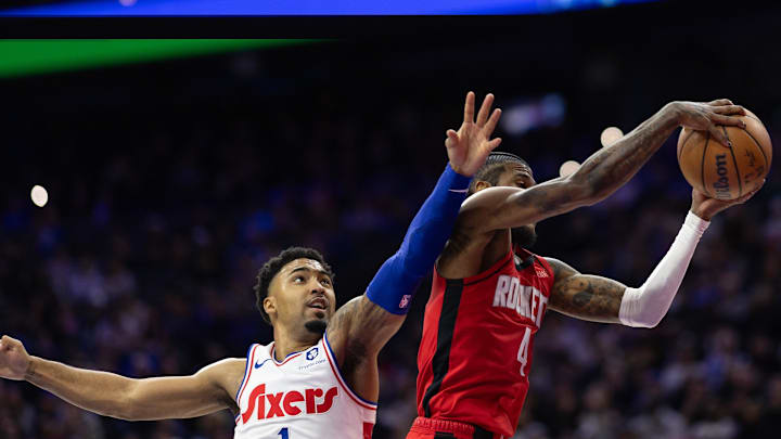 Nov 27, 2024; Philadelphia, Pennsylvania, USA; Houston Rockets guard Jalen Green (4) rebounds the ball past Philadelphia 76ers forward KJ Martin (1) during the second quarter at Wells Fargo Center. Mandatory Credit: Bill Streicher-Imagn Images