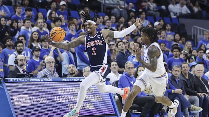Mar 7, 2024; Los Angeles, California, USA; Arizona Wildcats guard Caleb Love (2) attempts to save the ball from going out of bounds as UCLA guard Dylan Andrews (2) defends during the first half at Pauley Pavilion presented by Wescom.