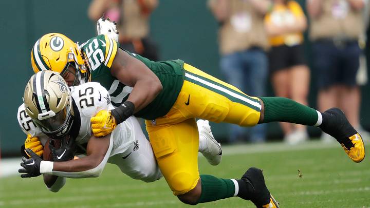 Green Bay Packers linebacker Kingsley Enagbare (55) tackles New Orleans Saints running back Kendre Miller (25) during their football game Sunday, September 24, 2023, at Lambeau Field in Green Bay, Wis.