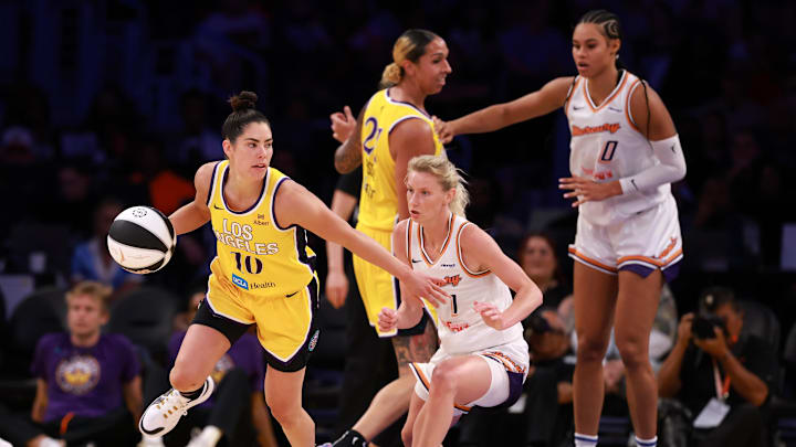 Jun 1, 2025; Los Angeles, California, USA;  Los Angeles Sparks guard Kelsey Plum (10) dribbles the ball against Phoenix Mercury guard Lexi Held (1) during the second quarter at Crypto.com Arena. Mandatory Credit: Kiyoshi Mio-Imagn Images
