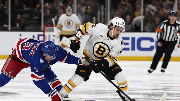 Jan 10, 2026; Boston, Massachusetts, USA; New York Rangers left wing Alexis Lafrenire (13) tries to slow down Boston Bruins center Marat Khusnutdinov (92) during the first period at TD Garden. Mandatory Credit: Winslow Townson-Imagn Images