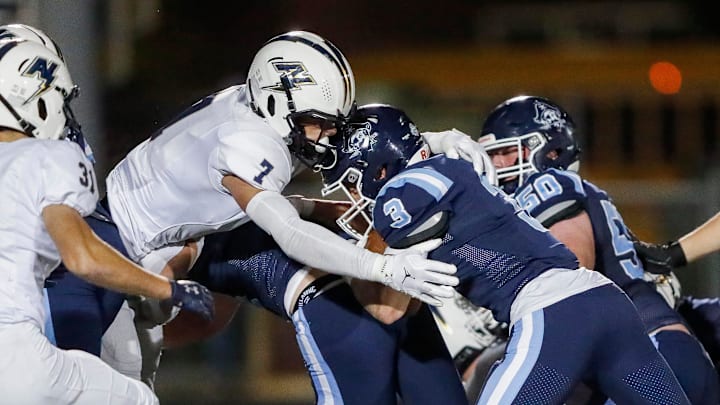 Appleton North High School's Ben Wenzel (7) meets Bay Port High School's Tommy Kemen (3) in the hole during a WIAA Division 1 first round playoff game on Friday, October 24, 2025, at Bay Port High School in Suamico, Wis. Bay Port won the game, 41-6.
