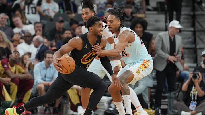 Apr 4, 2025; San Antonio, Texas, USA;  Cleveland Cavaliers guard Donovan Mitchell (45) dribbles against San Antonio Spurs guard Devin Vassell (24) in the second half at Frost Bank Center. Mandatory Credit: Daniel Dunn-Imagn Images