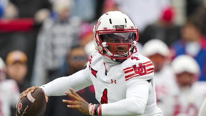 Nov 28, 2025; Lawrence, Kansas, USA; Utah Utes quarterback Devon Dampier (4) throws a pass during the first half against the Kansas Jayhawks at David Booth Kansas Memorial Stadium. Mandatory Credit: Jay Biggerstaff-Imagn Images