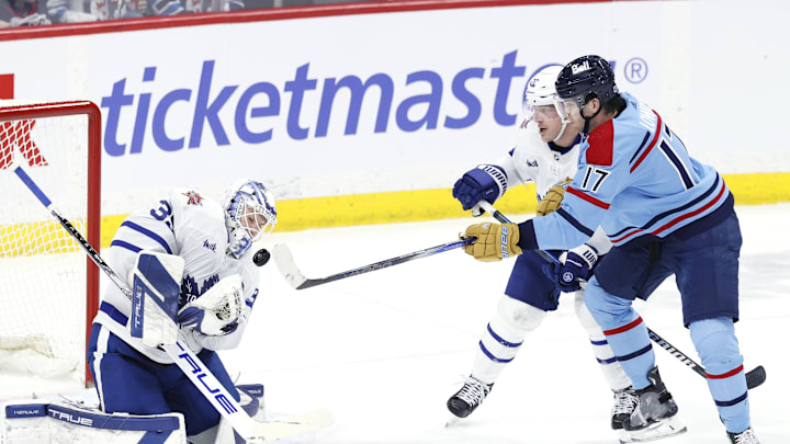 Jan 27, 2024; Winnipeg, Manitoba, CAN; Winnipeg Jets center Adam Lowry (17) tries to bat down the