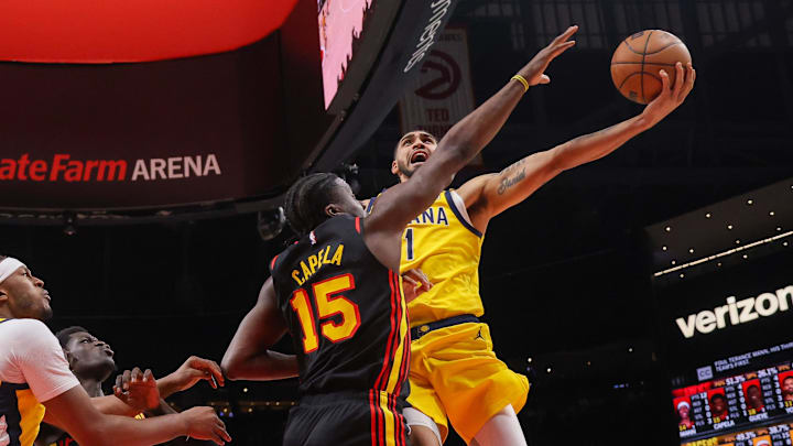 Mar 6, 2025; Atlanta, Georgia, USA; Indiana Pacers forward Obi Toppin (1) shoots past Atlanta Hawks center Clint Capela (15) in the fourth quarter at State Farm Arena. Mandatory Credit: Brett Davis-Imagn Images