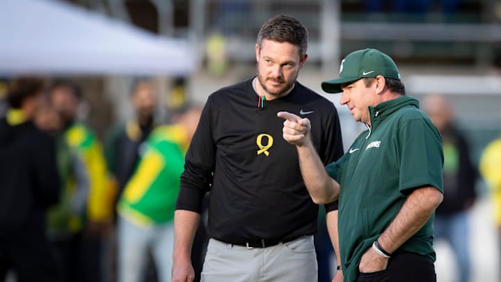 Oregon Ducks head coach Dan Lanning and Michigan State Spartans head coach Jonathan Smith talk before the game as the Ducks host the Spartans Friday, Oct. 4, 2024 at Autzen Stadium in Eugene, Ore.