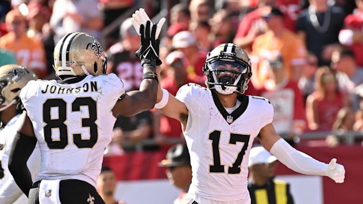 Jan 5, 2025; Tampa, Florida, USA; New Orleans Saints wide receiver Dante Pettis (17) celebrates with tight end Juwan Johnson (83) after catching a touchdown pass in the first half against the Tampa Bay Buccaneers at Raymond James Stadium. Mandatory Credit: Jonathan Dyer-Imagn Images Jan 5, 2025; Tampa, Florida, USA; New Orleans Saints wide receiver Dante Pettis (17) celebrates with tight end Juwan Johnson (83) after catching a touchdown pass in the first half against the Tampa Bay Buccaneers at Raymond James Stadium. Mandatory Credit: Jonathan Dyer-Imagn Images