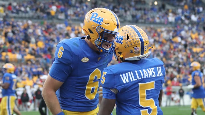 Oct 25, 2025; Pittsburgh, Pennsylvania, USA;  Pittsburgh Panthers quarterback Mason Heintschel (6) and wide receiver Raphael Williams Jr. (5) celebrate after combining for a touchdown against the North Carolina State Wolfpack during the second quarter at Acrisure Stadium. Mandatory Credit: Charles LeClaire-Imagn Images