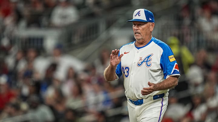 Aug 23, 2025; Cumberland, Georgia, USA; Atlanta Braves manager Brian Snitker (43) walks to the mound to change pitchers against the New York Mets during the seventh inning at Truist Park. Mandatory Credit: Dale Zanine-Imagn Images