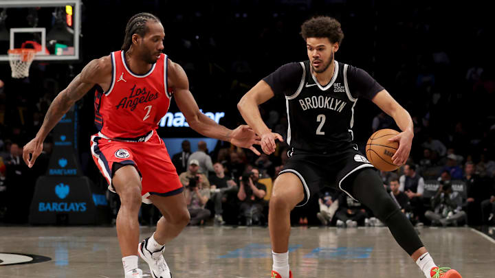 Mar 28, 2025; Brooklyn, New York, USA; Brooklyn Nets forward Cameron Johnson (2) controls the ball against Los Angeles Clippers forward Kawhi Leonard (2) during the third quarter at Barclays Center. Mandatory Credit: Brad Penner-Imagn Images