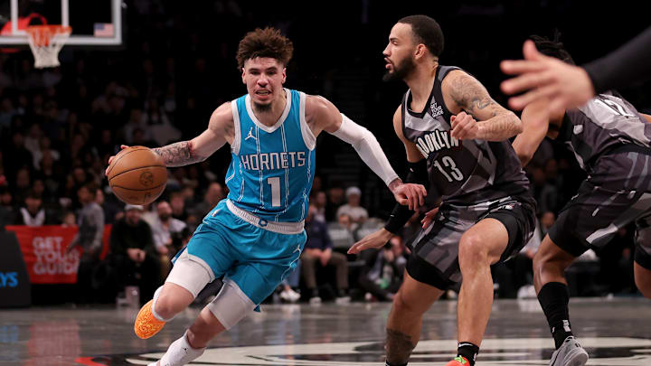Feb 10, 2025; Brooklyn, New York, USA; Charlotte Hornets guard LaMelo Ball (1) drives around Brooklyn Nets guard Tyrese Martin (13) during the first quarter at Barclays Center. Mandatory Credit: Brad Penner-Imagn Images