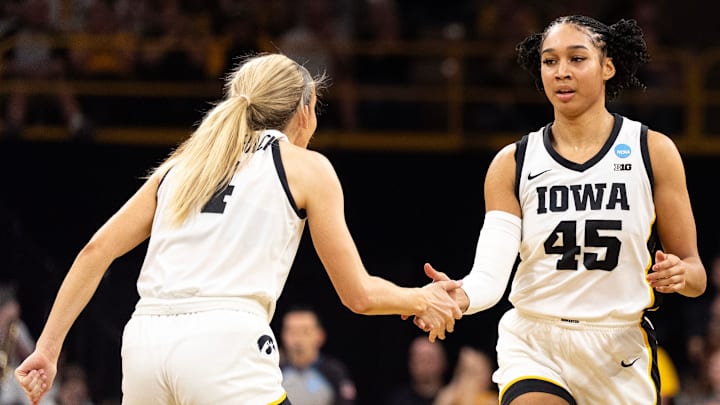 Iowa guard Kylie Feuerbach (4) high-fives Iowa forward Hannah Stuelke (45) March 21, 2026 during a First Round NCAA March Madness game against the Fairleigh Dickinson Knights at Carver-Hawkeye Arena in Iowa City, Iowa.