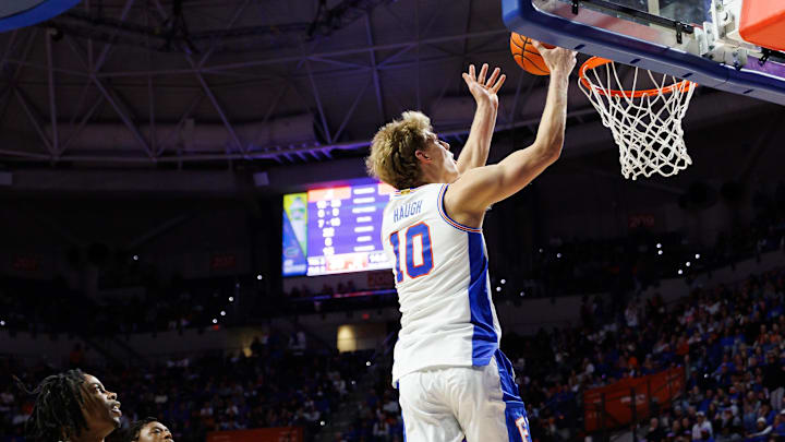 Feb 1, 2026; Gainesville, Florida, USA; Florida Gators forward Thomas Haugh (10) makes a layup over Alabama Crimson Tide guard Latrell Wrightsell Jr. (3) during the second half at Exactech Arena at the Stephen C. O'Connell Center.
