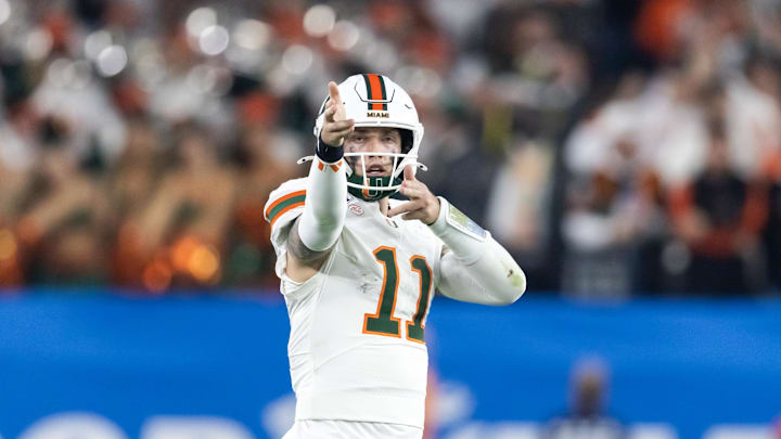 Jan 8, 2026; Glendale, AZ, USA; Miami Hurricanes quarterback Carson Beck (11) celebrates a play against the Mississippi Rebels during the 2026 Fiesta Bowl and semifinal game of the College Football Playoff at State Farm Stadium. Mandatory Credit: Mark J. Rebilas-Imagn Images
