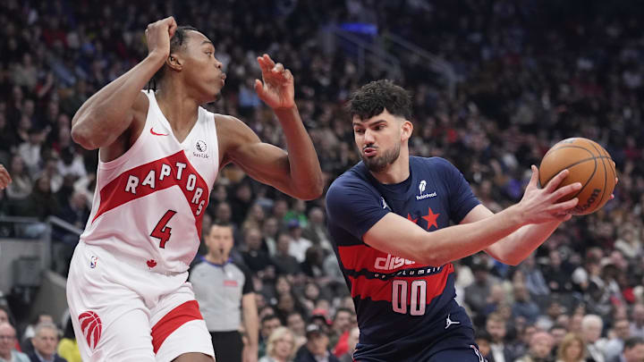 Mar 10, 2025; Toronto, Ontario, CAN; Washington Wizards forward Tristan Vukcevic (00) drives to the net against Toronto Raptors guard Scottie Barnes (4) during the first half at Scotiabank Arena. Mandatory Credit: John E. Sokolowski-Imagn Images Mar 10, 2025; Toronto, Ontario, CAN; Washington Wizards forward Tristan Vukcevic (00) drives to the net against Toronto Raptors guard Scottie Barnes (4) during the first half at Scotiabank Arena. Mandatory Credit: John E. Sokolowski-Imagn Images