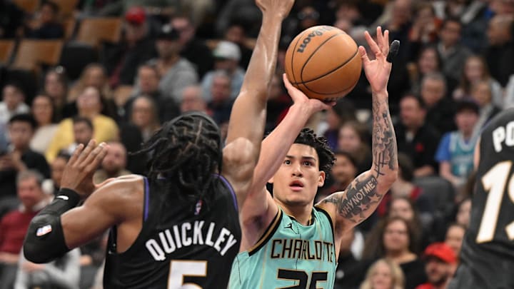 Mar 28, 2025; Toronto, Ontario, CAN; Charlotte Hornets guard KJ Simpson (25) shoots the ball as Toronto Raptors guard Immanuel Quickley (5) defends in the second half at Scotiabank Arena. Mandatory Credit: Dan Hamilton-Imagn Images