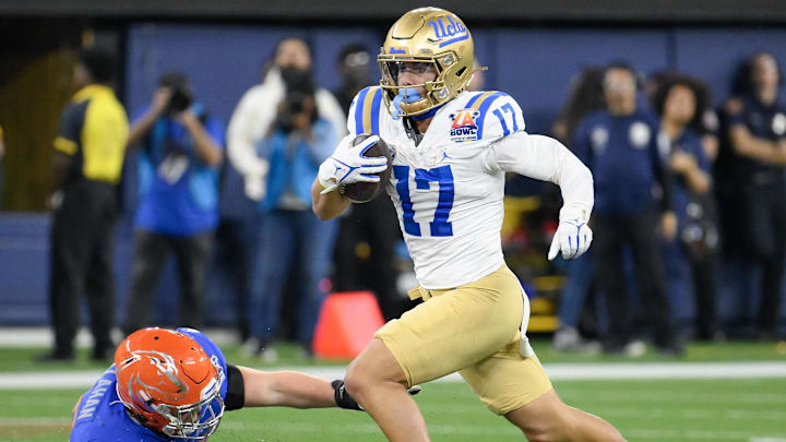 Dec 16, 2023; Inglewood, CA, USA; UCLA Bruins wide receiver Logan Loya (17) runs past Boise State Broncos defensive tackle Michael Callahan (92) during the first quarter of the Starco Brands LA Bowl at SoFi Stadium. Mandatory Credit: Robert Hanashiro-Imagn Images