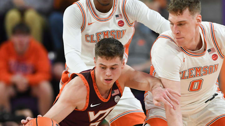 Mar 8, 2025; Clemson, SC, USA;  Virginia Tech guard Brandon Rechsteiner (7) and Clemson center Viktor Lakhin (0) reach for a loose ball during the first half at Littlejohn Coliseum in Clemson, S.C Saturday, March 8, 2025.  Mandatory Credit: Ken Ruinard/USA TODAY Network via Imagn Images 