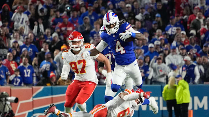 Nov 2, 2025; Orchard Park, New York, USA; Buffalo Bills running back James Cook III (4) leaps over Kansas City Chiefs safety Bryan Cook (6)