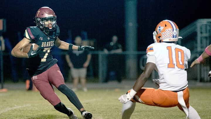 Lake Gibson's Derrick McBride tries to make a cut against Bartow's Corey Butler on Friday night at Virgil Ramage Stadium. Lake Gibson's Derrick McBride tries to make a cut against Bartow's Corey Butler on Friday night at Virgil Ramage Stadium.