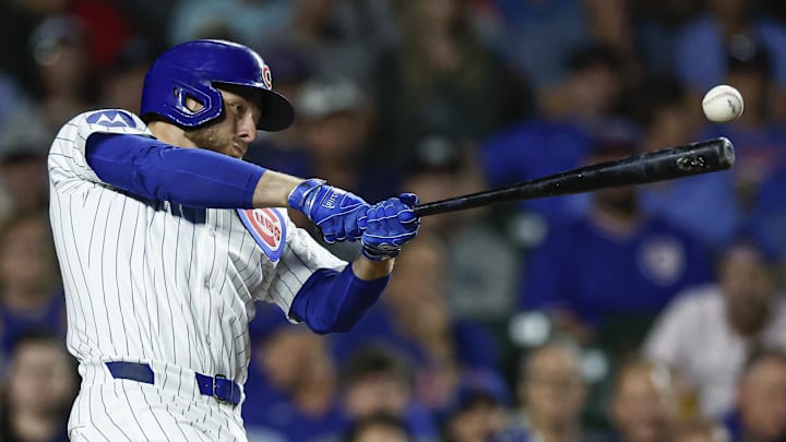 Sep 17, 2024; Chicago, Illinois, USA; Chicago Cubs first baseman Michael Busch (29) hits an RBI-single against the Oakland Athletics during the third inning at Wrigley Field. Mandatory Credit: Kamil Krzaczynski-Imagn Images
