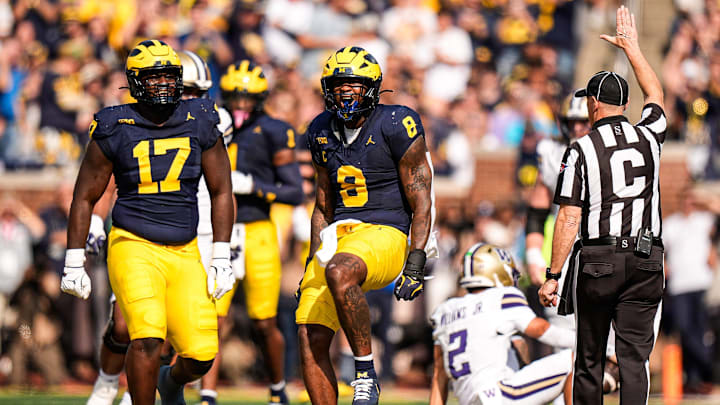 Michigan edge Derrick Moore (8) celebrates a sack against Washington quarterback Demond Williams Jr. (2) during the first half at Michigan Stadium in Ann Arbor on Saturday, Oct. 18, 2025.