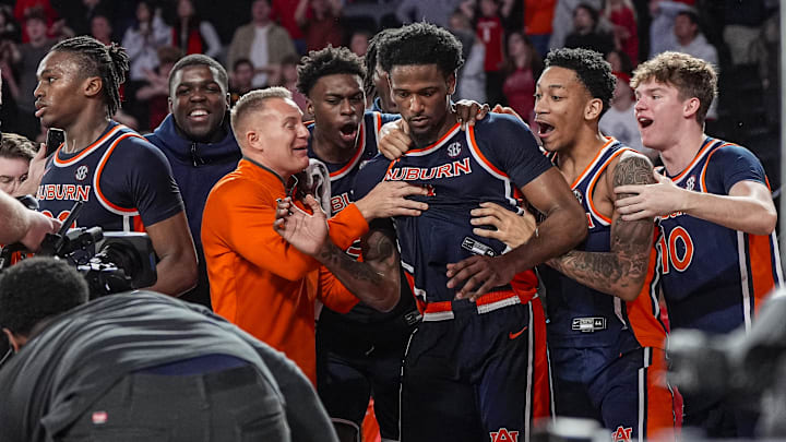 Jan 3, 2026; Athens, Georgia, USA; Auburn Tigers guard Kevin Overton (1) reacts with teammates after tying the game against the Georgia Bulldogs as time expired during the second half at Stegeman Coliseum. Mandatory Credit: Dale Zanine-Imagn Images Jan 3, 2026; Athens, Georgia, USA; Auburn Tigers guard Kevin Overton (1) reacts with teammates after tying the game against the Georgia Bulldogs as time expired during the second half at Stegeman Coliseum. Mandatory Credit: Dale Zanine-Imagn Images