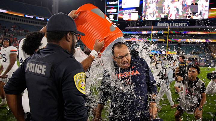 Virginia Cavaliers head coach Tony Elliott is doused with Gatorade after winning the TaxSlayer Gator Bowl at EverBank Stadium Saturday December 27, 2025 in Jacksonville, Fla. Virginia defeated Missouri 13-7. [Doug Engle/Florida Times-Union]