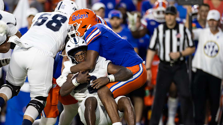 Sep 7, 2024; Gainesville, Florida, USA; Florida Gators edge LJ McCray (17) tackles Samford Bulldogs quarterback Quincy Crittendon (2) during the first half at Ben Hill Griffin Stadium. Mandatory Credit: Matt Pendleton-Imagn Images