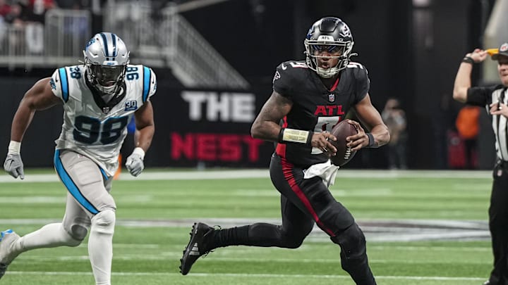 Jan 5, 2025; Atlanta, Georgia, USA; Atlanta Falcons quarterback Michael Penix Jr. (9) runs against the Carolina Panthers during the second half at Mercedes-Benz Stadium. Mandatory Credit: Dale Zanine-Imagn Images