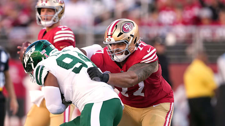 Sep 9, 2024; Santa Clara, California, USA; San Francisco 49ers guard Dominick Puni (77) blocks New York Jets defensive end Solomon Thomas (left) during the first quarter at Levi's Stadium. Mandatory Credit: Darren Yamashita-Imagn Images