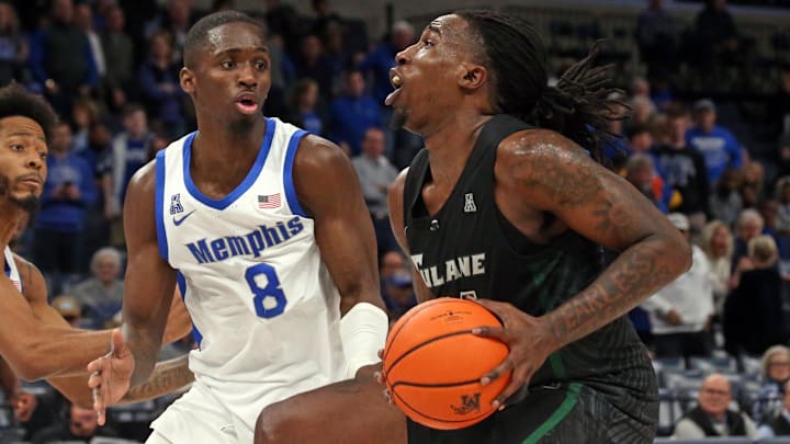 Feb 11, 2024; Memphis, Tennessee, USA; Tulane Green Wave forward Kevin Cross (24) drives to the basket as Memphis Tigers forward David Jones (8) defends during the second half at FedExForum. Mandatory Credit: Petre Thomas-Imagn Images