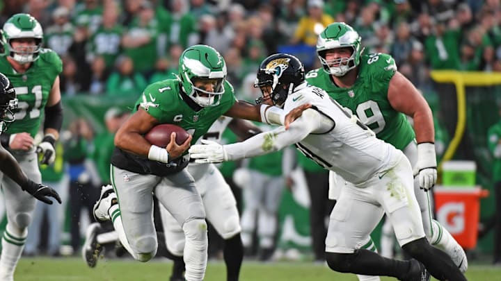 Nov 3, 2024; Philadelphia, Pennsylvania, USA; Philadelphia Eagles quarterback Jalen Hurts (1) tires to get past Jacksonville Jaguars defensive end Arik Armstead (91) during the second quarter at Lincoln Financial Field. Mandatory Credit: Eric Hartline-Imagn Images
