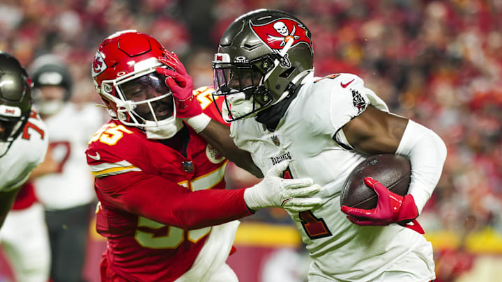 Nov 4, 2024; Kansas City, Missouri, USA; Tampa Bay Buccaneers running back Rachaad White (1) runs the ball against Kansas City Chiefs linebacker Joshua Uche (55) during the first half at GEHA Field at Arrowhead Stadium. Mandatory Credit: Jay Biggerstaff-Imagn Images