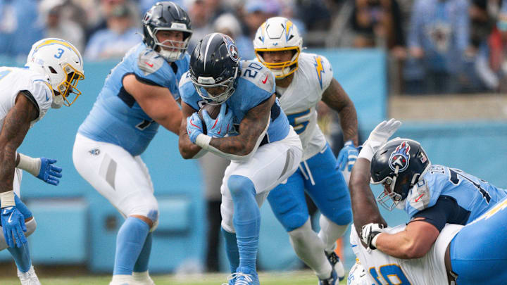 Nov 2, 2025; Nashville, Tennessee, USA;  Tennessee Titans running back Tony Pollard (20) runs with the ball against the Los Angeles Chargers during the first half at Nissan Stadium. Mandatory Credit: Steve Roberts-Imagn Images