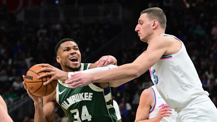 Jan 23, 2025; Milwaukee, Wisconsin, USA; Milwaukee Bucks forward Giannis Antetokounmpo (34) drives for the basket against Miami Heat forward Nikola Jovic (5) in the third quarter at Fiserv Forum. Mandatory Credit: Benny Sieu-Imagn Images