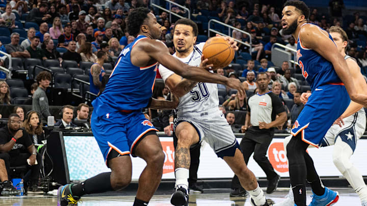 Dec 15, 2024; Orlando, Florida, USA; Orlando Magic guard Cole Anthony (50) drives to the basket against New York Knicks forward OG Anunoby (8) in the fourth quarter at Kia Center. Mandatory Credit: Jeremy Reper-Imagn Images
