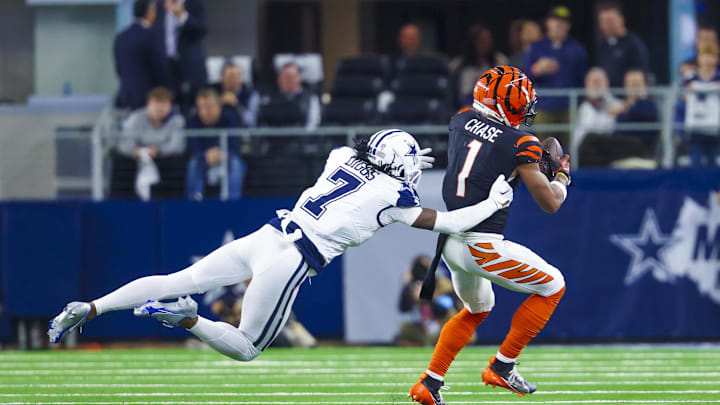 Dec 9, 2024; Arlington, Texas, USA;  Cincinnati Bengals wide receiver Ja'Marr Chase (1) catches a pass as Dallas Cowboys cornerback Trevon Diggs (7) defends during the second half at AT&T Stadium. Mandatory Credit: Kevin Jairaj-Imagn Images