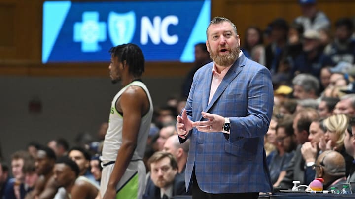 Dec 30, 2023; Durham, North Carolina, USA; Queens Royals head coach Grand Leonard (right) reacts