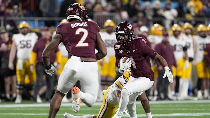 Jan 3, 2025; Charlotte, NC, USA; Virginia Tech cornerback Dante Lovett (1) runs after his interception against Minnesota.