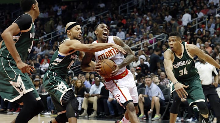 Mar 25, 2016; Atlanta, GA, USA; Atlanta Hawks guard Jeff Teague (0) drives against Milwaukee Bucks forward John Henson (31), guard Jerryd Bayless (19) and forward Giannis Antetokounmpo (34) in the fourth quarter of their game at Philips Arena. The Hawks won 101-90. Mandatory Credit: Jason Getz-Imagn Images